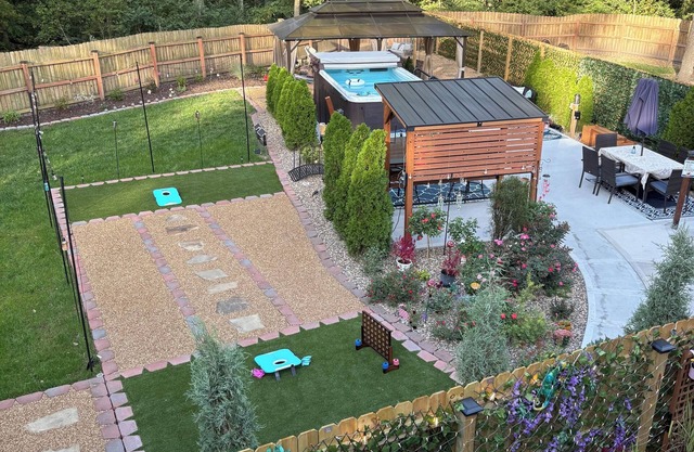 Private Urban Oasis with heated pool spa, outdoor bar and TV, firepit, corn hole