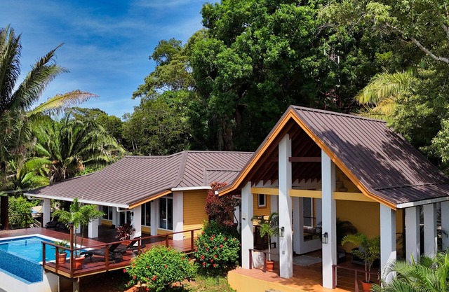 Relax at this hillside retreat that overlooks the lush forest and the Caribbean.