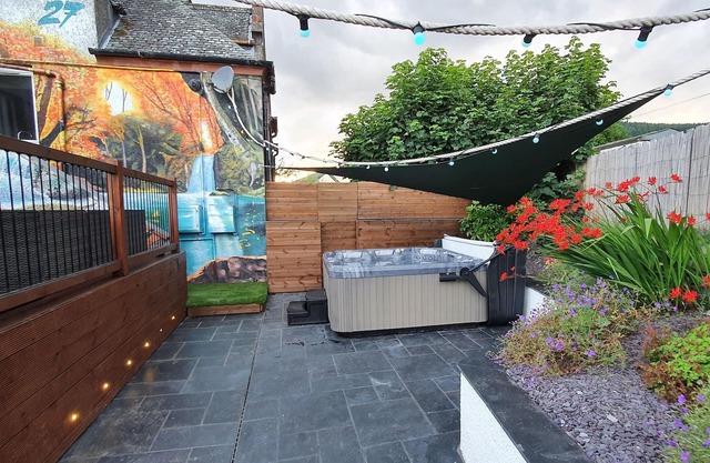 Relax in this luxury renovated flat with a hot tub and log burner