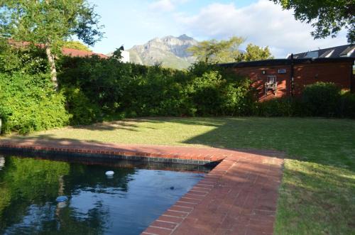 Retro Red Stone Villa with pool & lush garden