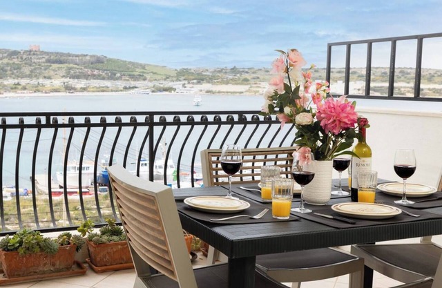Seafront apartment just steps from Mellieħa Bay, with stunning views of the bay and Red Tower. Enjoy spectacular sunsets, walk to nearby restaurants and amenities, and catch the bus right outside.