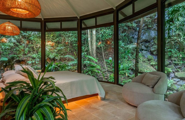 Serene jungle treehouse with waterfall hikes, AC, balcony & king bed