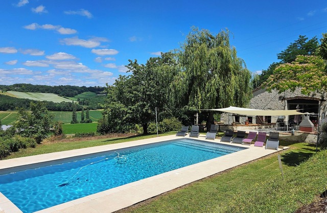 Spacious, beautifully converted barn with exposed wooden beams, swimming pool