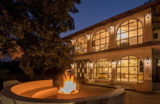 StayVista's Casa Blanca - Modern elegance with a pool, spacious lawn & diverse activities