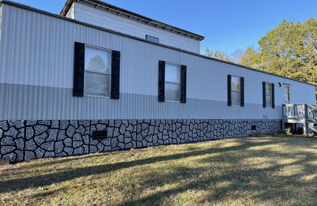 Terrific 2-bedroom mobile home with plenty of outdoor space to enjoy nature.