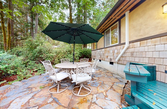 Tree-lined retreat with wood fireplace, board game collection, & pool access