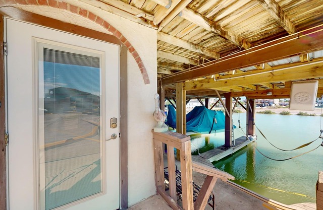 Waterfront condo with an outdoor pool, washer/dryer, & central AC