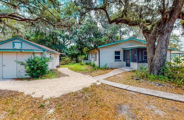 Waterfront stay with a dock, firepit, grill, sunroom, separate studio, W/D, & AC