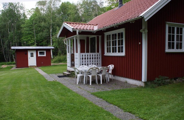 Wooden house near a lake, with a boat