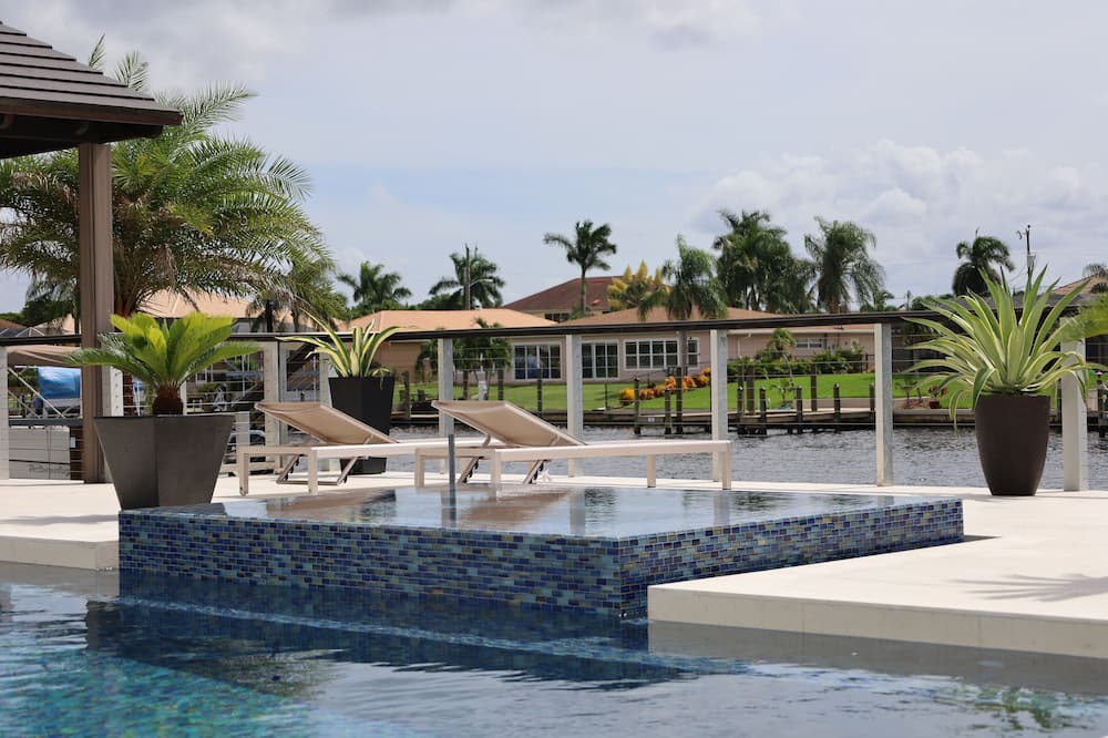 Caloosahatchee House | Custom Home with tile pool, boating dock and every comfort
