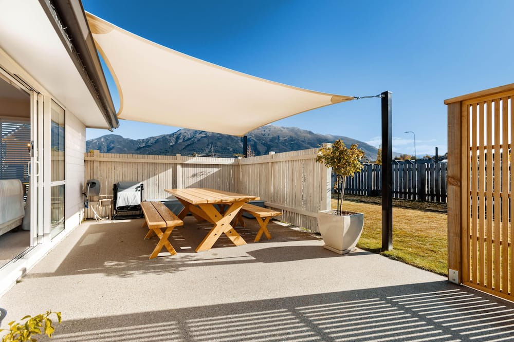 Lake Hawea House | Home nestled in Hawea - A four-bedroom Hawea home with mountain views. Enjoy a modern kitchen, spacious living areas, two bathrooms, and a cosy fireplace