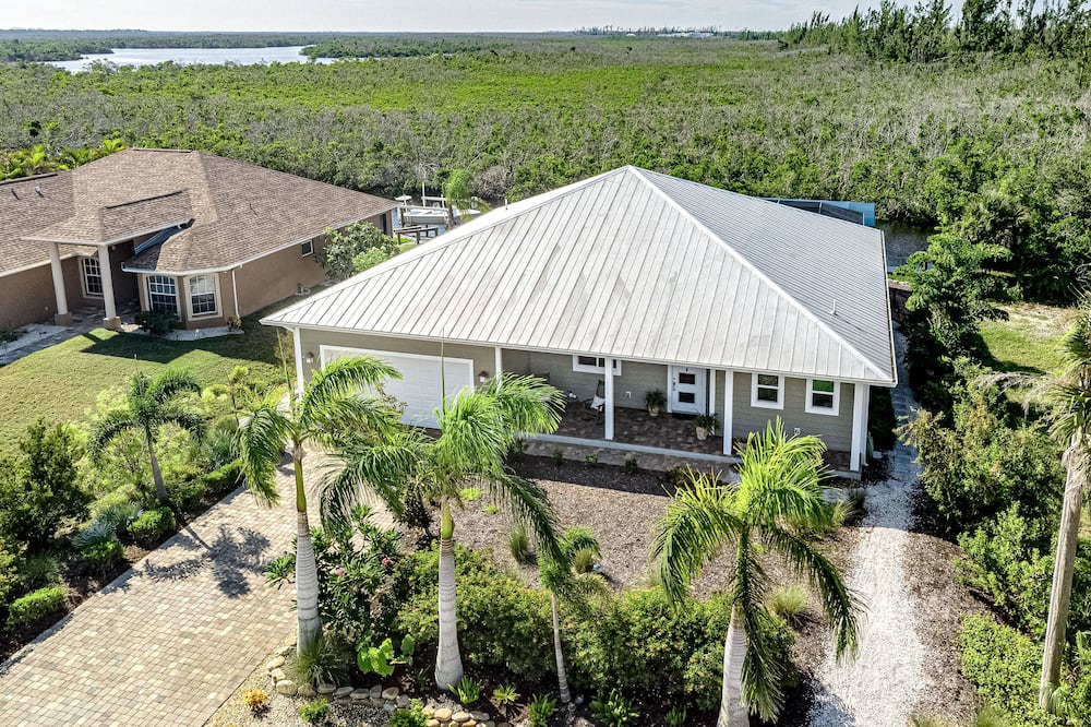 Pine Island Center House | Canal-side charmer with enclosed pool, waterside deck, open layout, & W/D