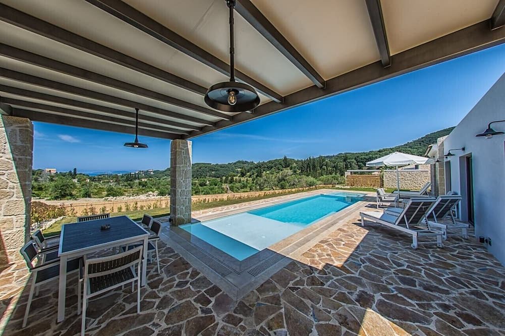 Kavvadades Villa | Alluring Corfu Villa | Villa Corallia | 2 Bedrooms | Spacious Furnished Terrace with Shaded Outdoor Dining Area | Private Garden, Pool and Hot Tub | Prime Location | Arillas, Mega Lithari