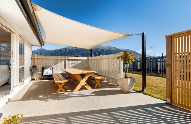 Home nestled in Hawea - A four-bedroom Hawea home with mountain views. Enjoy a modern kitchen, spacious living areas, two bathrooms, and a cosy fireplace