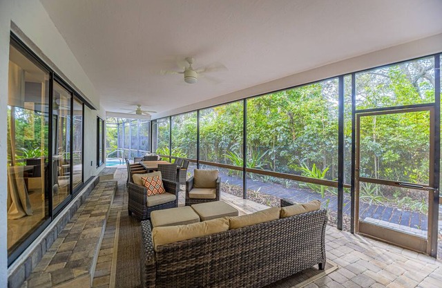 Gorgeous Naples home with open-concept layout, sunroom, enclosed pool, & AC