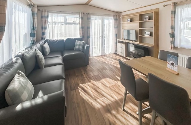 Modern and contemporary 12ft-wide caravan with one double and two twin.