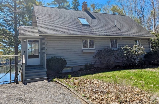 Charming riverfront home with cozy interiors, dock, and scenic deck views
